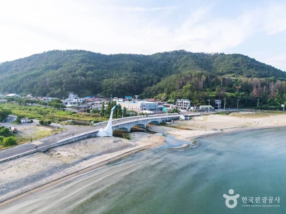 Wolpo Beach in Pohang, with its sandy shore and the bridge near the southern end.
