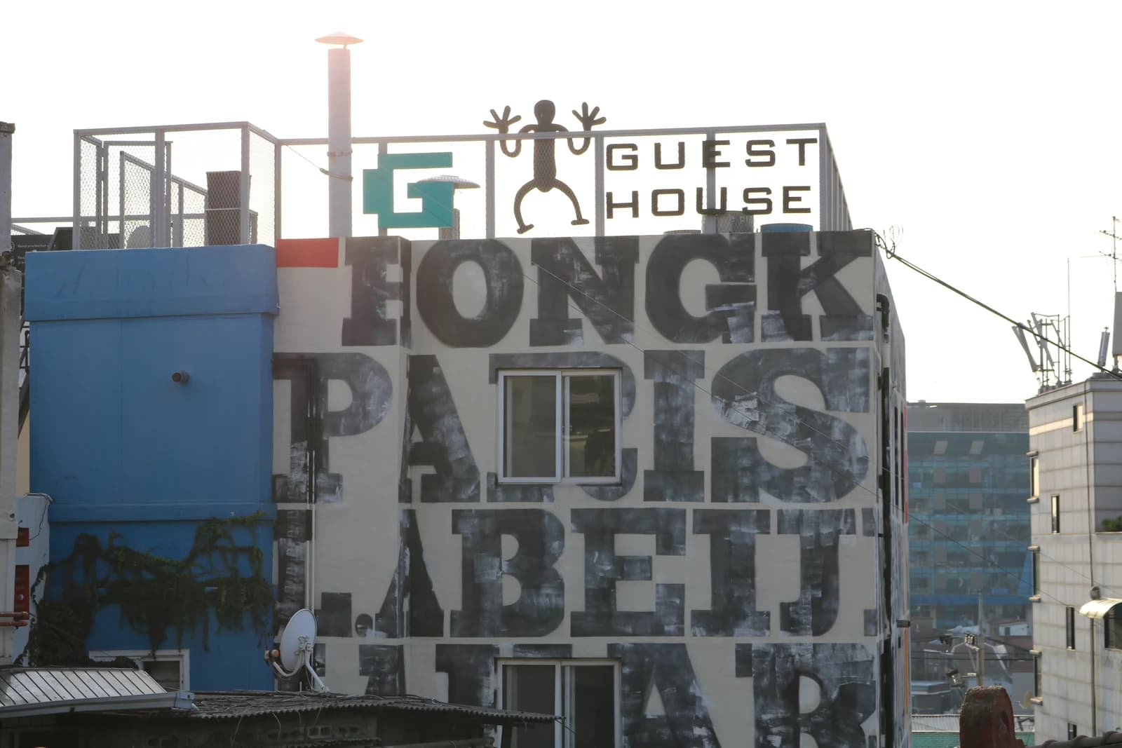 G Guesthouse’s rooftop sign and painted exterior in Itaewon, photographed in 2022.