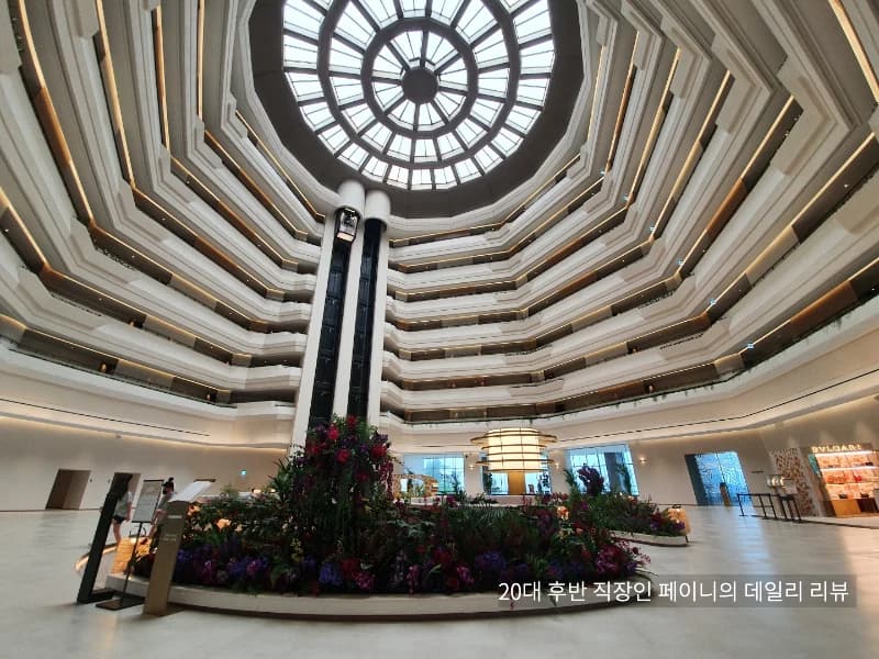 The glass-roofed atrium lobby at Parnas Hotel Jeju, photographed in 2022.