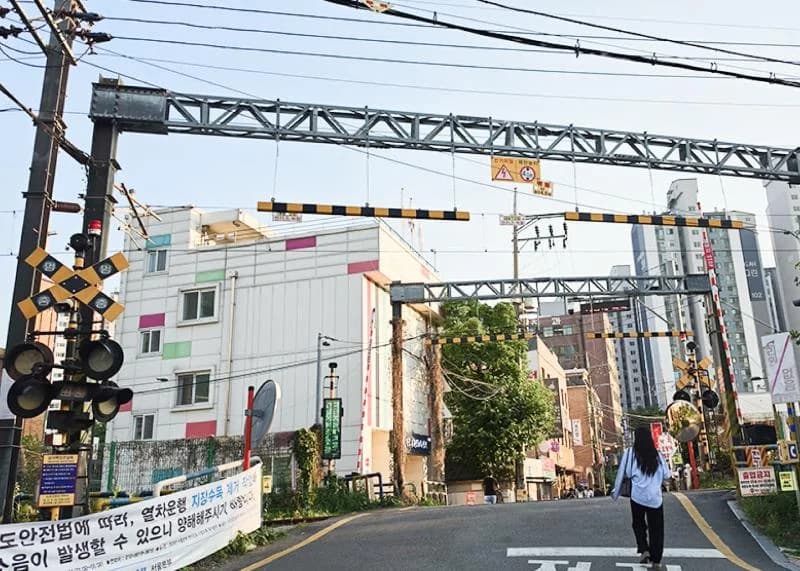 Baekbin Railroad Crossing in the real Yongsan neighborhood behind My Mister’s Hugye.